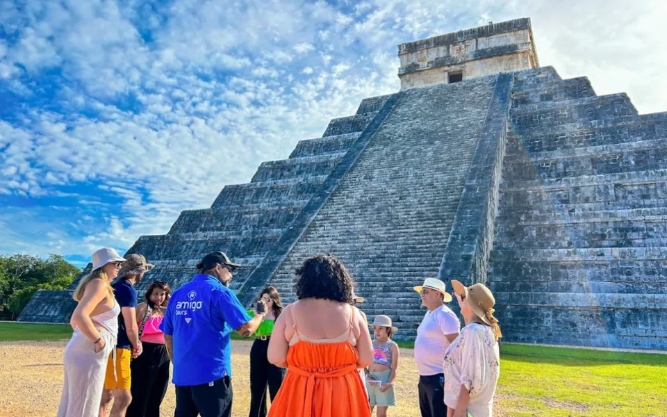An Amigo Tours guide leading guests at Chichén Itzá, featured by Skift